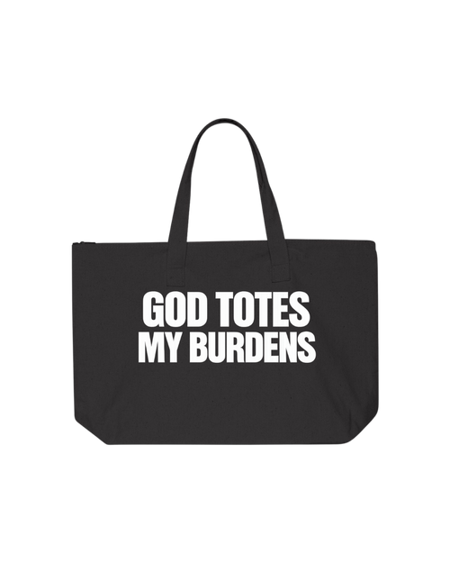 Large black 100% cotton canvas Christian faith tote bag with bold white block lettering that reads God Totes My Burdens. Zipper closure, interior pocket, and sturdy shoulder handles.