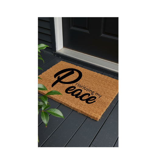 “Christian doormat with the phrase ‘Prioritizing My Peace’ in bold black lettering, natural coir texture, by The Redeemed Brand.”